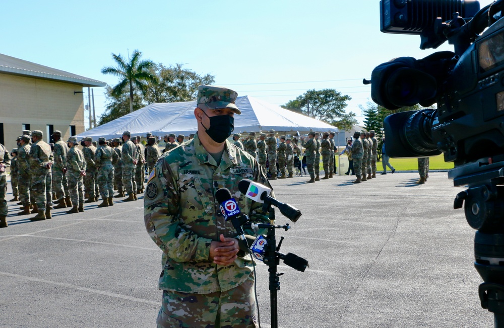 Army Officer answers questions to local media during deployment departure ceremony