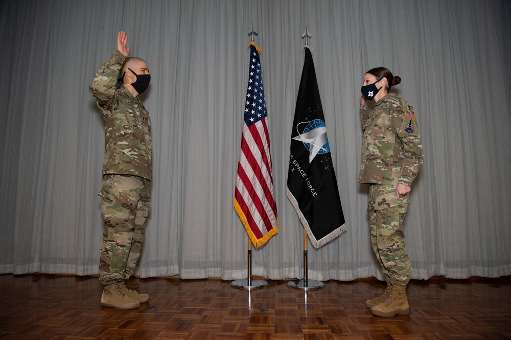 Maj. Jonathan Arehart administers the oath of office during Chief Master Sergeant April Brittain’s USSF transfer ceremony