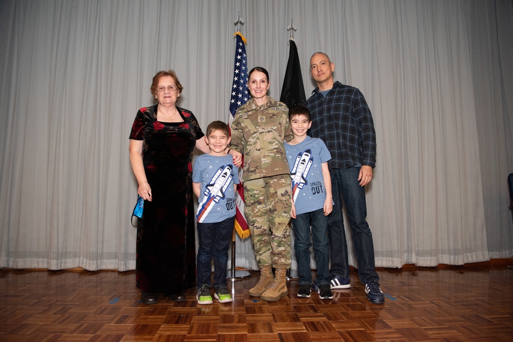 Chief Master Sergeant April Brittain poses with family after transfer ceremony into USSF