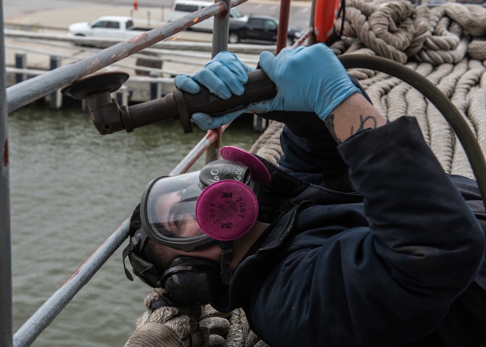 Sailor performs maintinence on guard rails on the fantail aboard the aircraft carrier USS John C. Stennis (CVN 74)