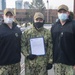 Hull Technician 3rd Class Aaron Rogers, middle, poses with Cmdr. John Benda, left, commanding officer of USS Constitution, and Chief Boatswain’s Mate James Gainey after being frocked to the rank of petty officer third class.