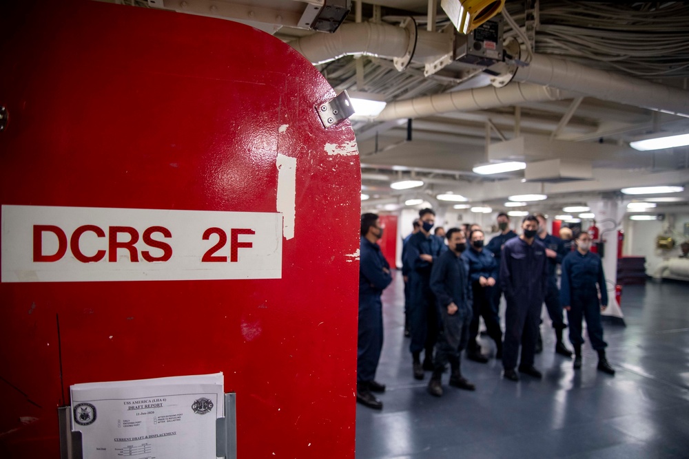 Sailors aboard USS America participate in a simulated casualty.