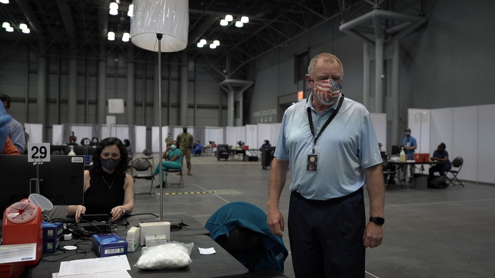 Staff workers at the Javits NY vaccination site receive the vaccine