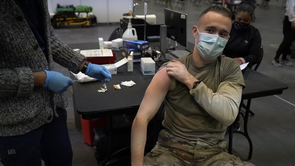 Staff workers at the Javits NY vaccination site receive the vaccine