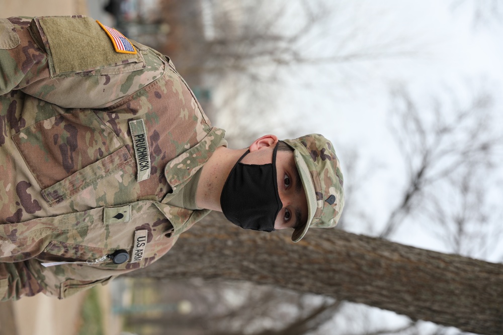 A Soldier from the 114th Infantry stands guard near the Capitol.