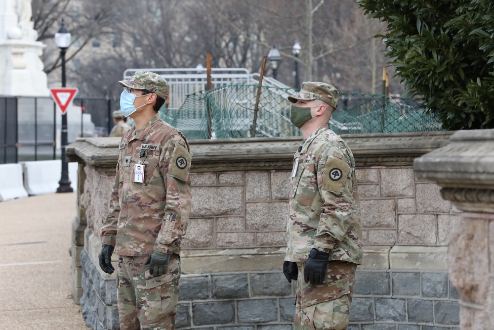 Soldiers with the 114th Infantry stand near the Capitol.