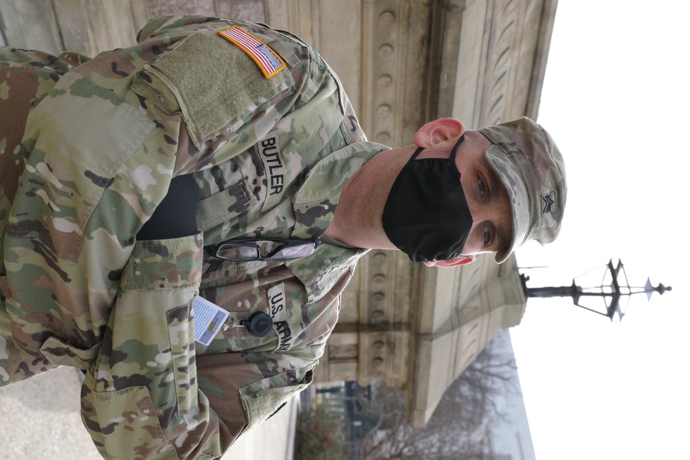 A Soldier with the 114th Infantry stands near the Capitol.