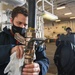 USS America (LHA 6)'s Sailor polishes aqueous film forming foam hose.