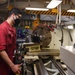 USS America (LHA 6)'s Sailor cuts bolt.
