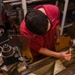 USS America (LHA 6)'s Sailor measures bolt.