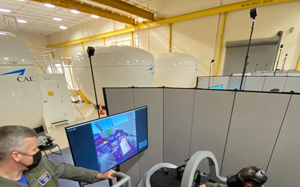 Air Force Maj. Gen. Craig D. Wills, Commander, 19th Air Force, experiences simulator