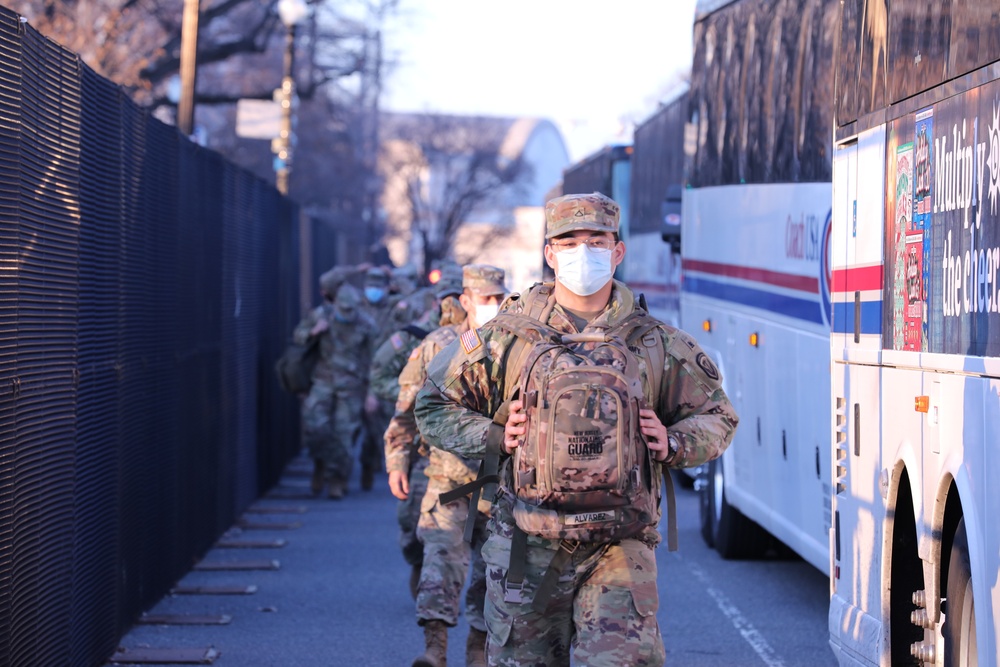 U.S. Soldiers with the New Jersey National Guard arrive for their guard shift near the Capitol building.