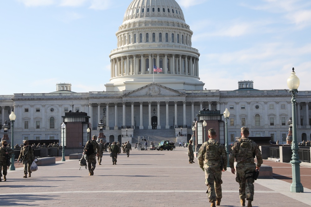 U.S. Soldiers walk towards the Capitol building.