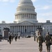 U.S. Soldiers walk towards the Capitol building.