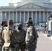 Soldiers with 1173rd Transportation Company discuss the next steps for their security shift.