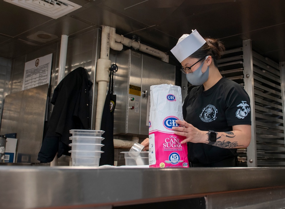 USS America (LHA 6) Sailor measures sugar