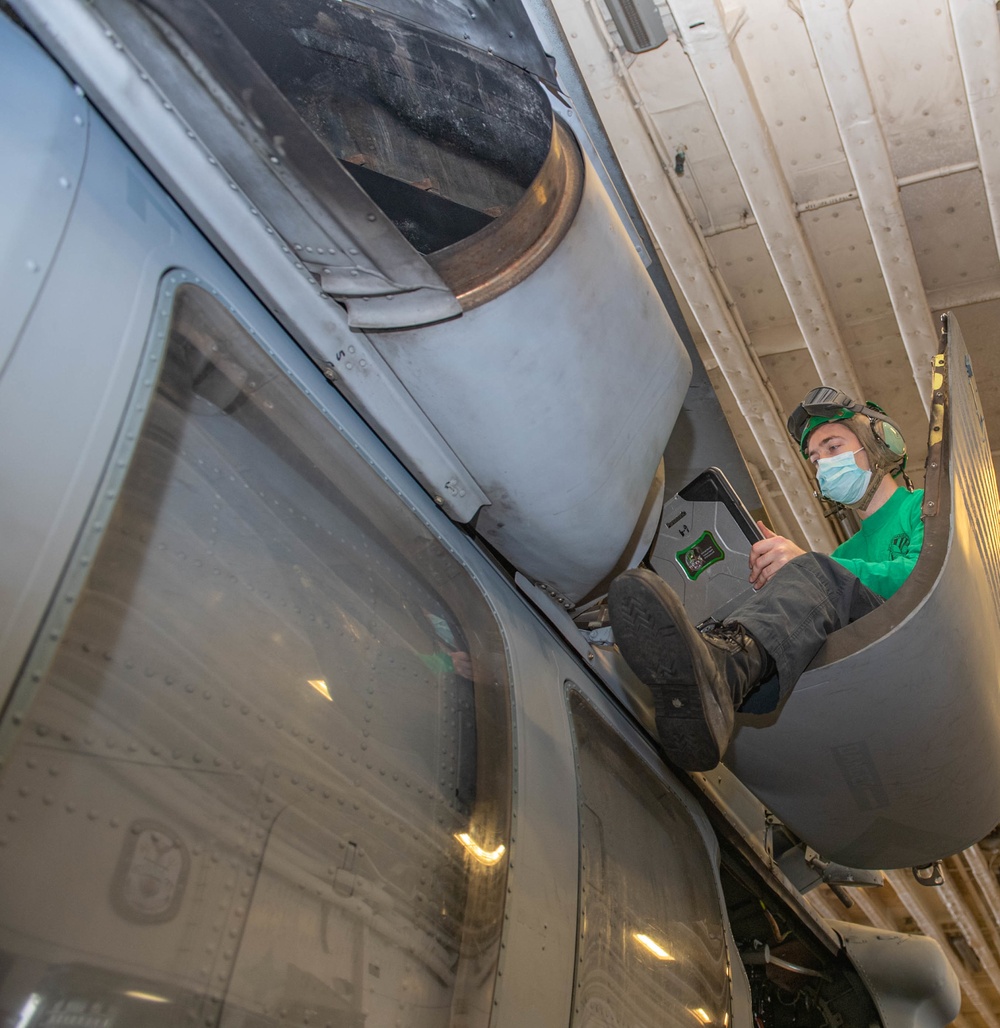 USS America (LHA 6) Sailor performs maintenance.