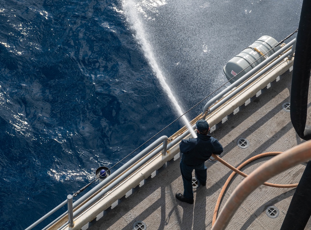 USS America (LHA 6) Sailor discharges water.