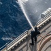 USS America (LHA 6) Sailor discharges water.