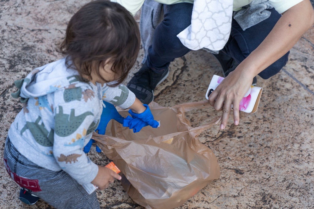 Members of the U.S. military community clean up American Village