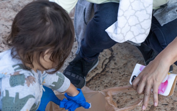 Members of the U.S. military community clean up American Village