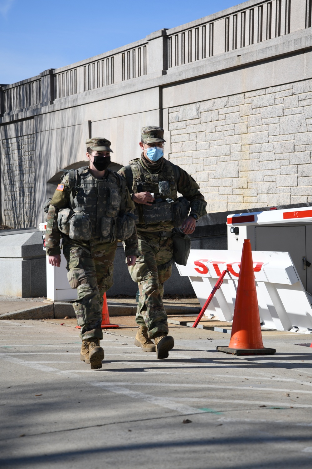 U.S. Army Spc. Victoria Orlando, a combat medic specialist, walks along the perimeter of a building in Washington, D.C., Jan. 14, 2021