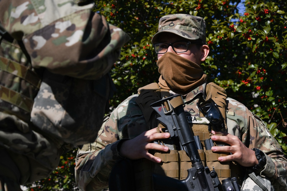 U.S. Army Pfc. Brian Jara, an infantry soldier, answers questions from a soldier while postured at his post in Washington, D.C., Jan. 14, 2021