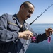 Nimitz Chief Fishes Off Fantail