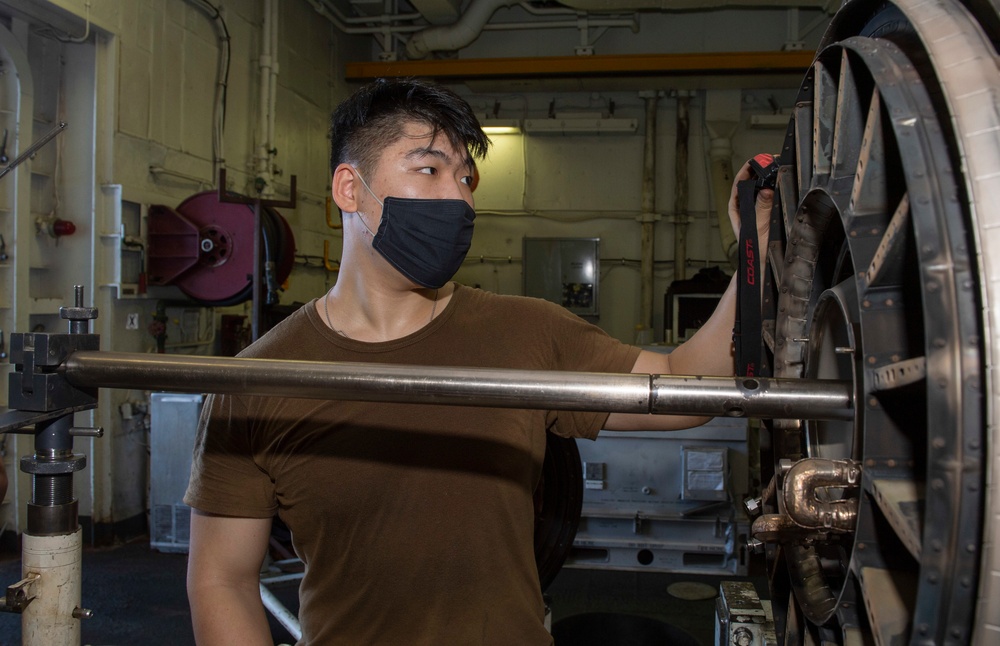 Nimitz Sailor Performs Maintenance on a Jet Engine