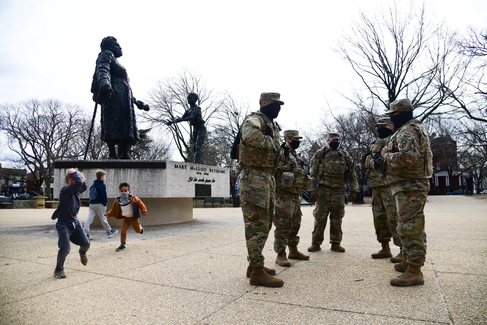 U.S. Soldiers with 933rd Military Police Company, Illinois National Guard, stand guard near the Mary McLeod Bethune Memorial Statue in Lincoln Park in Washington, D.C., Jan. 18, 2021