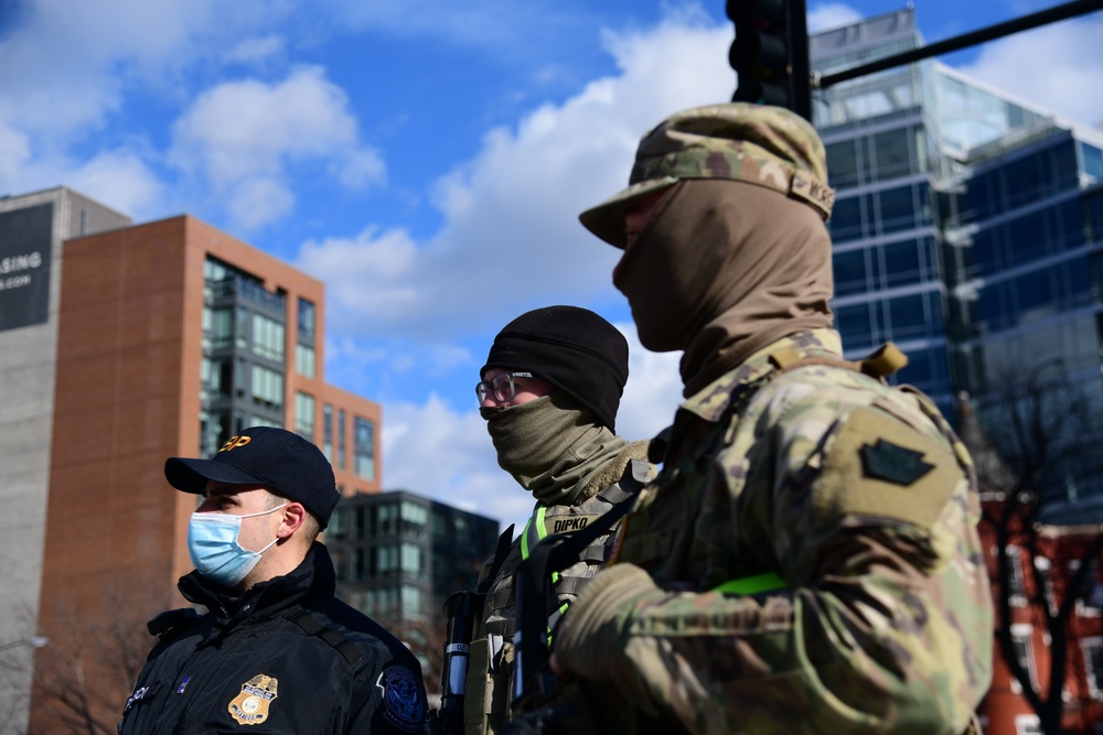 U.S. Army Spc. Matthew Morgan and Pfc. Landon Dipko work with Custom Border and Patrol officers to provide security in Washington, D.C.