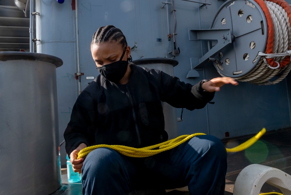 USS America (LHA 6) Sailor sets up heaving lines.