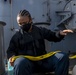 USS America (LHA 6) Sailor sets up heaving lines.