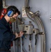 USS America (LHA 6) Sailor troubleshoots a net terminal box.