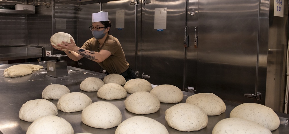 USS America (LHA 6) Sailor weighs dough