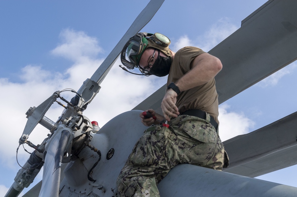 USS America (LHA 6) Sailor performs maintenance.