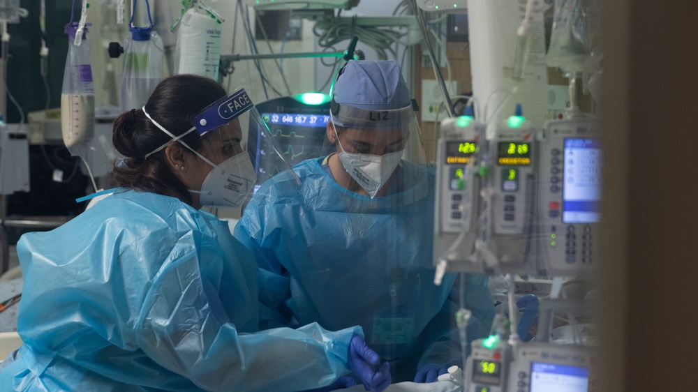 U.S. Air Force clinical nurse assists medical personnel at Harbor-UCLA Medical Center