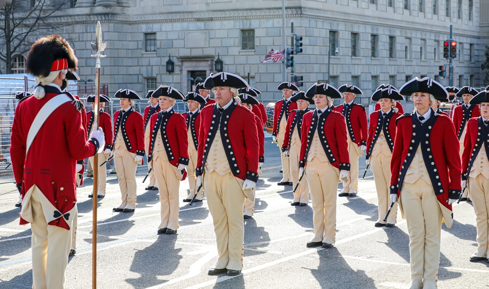 The U.S. Army Old Guard Fife and Drum Corps Soldiers stand in formation