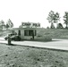 Black and white photo of 1943 entrance check-point of Camp Polk with one-star car.