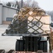 Airmen from the 133rd load duffel bags from the 682nd Engineer Battalion into a C-130 Hercules to Washington D.C.