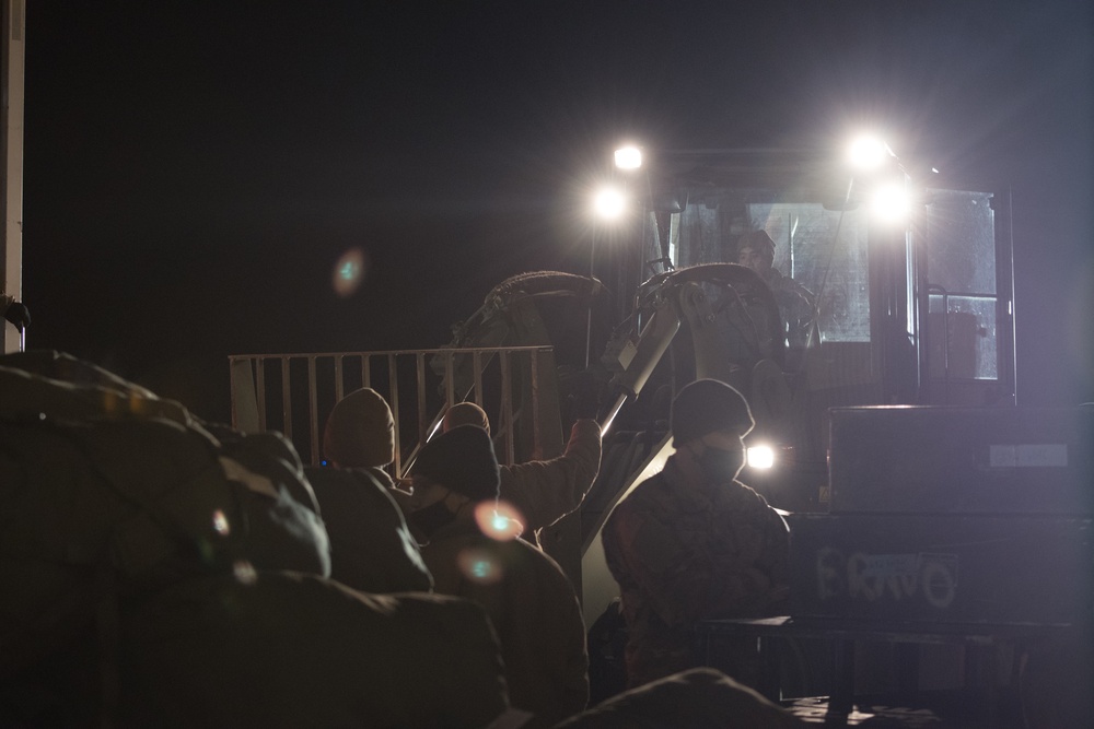 Soldiers from the 682nd Engineer Battalion load gear into a truck at Joint Base Andrews Airfield.