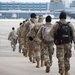 Soldiers from the 682nd Engineer Battalion move to board a C-130 Hercules at the 133rd Airlift Wing to Washington D.C.