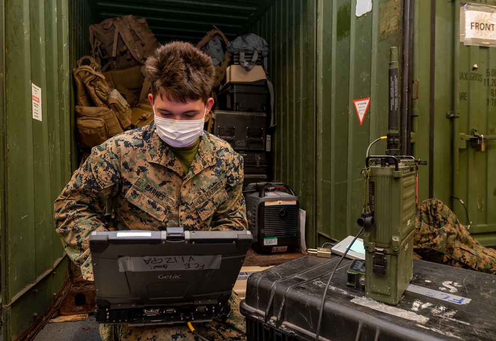 31st MEU Marine sets up high-frequency radio.