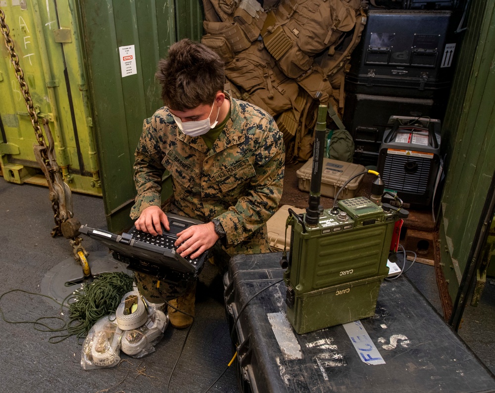 31st MEU Marine sets up high-frequency radio.