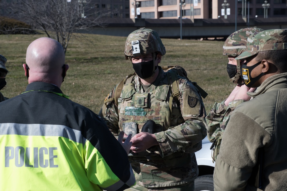 Command team of 682nd Engineer Battalion, MN National Guard, speak with local D.C. Law Enforcement Officer.