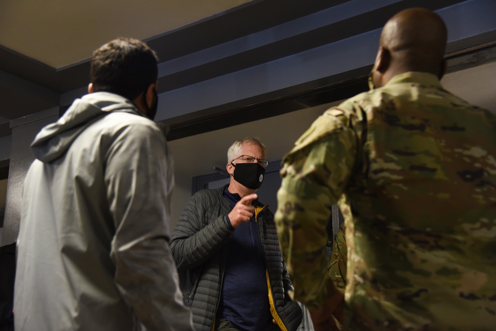 Christopher C. Miller, center, the acting secretary of defense, speaks with U.S. Army Lt. Col. Malik Freeman and Mr. Kashyap P. Patel at the D.C. Armory in Washington, D.C., Jan. 16, 2021