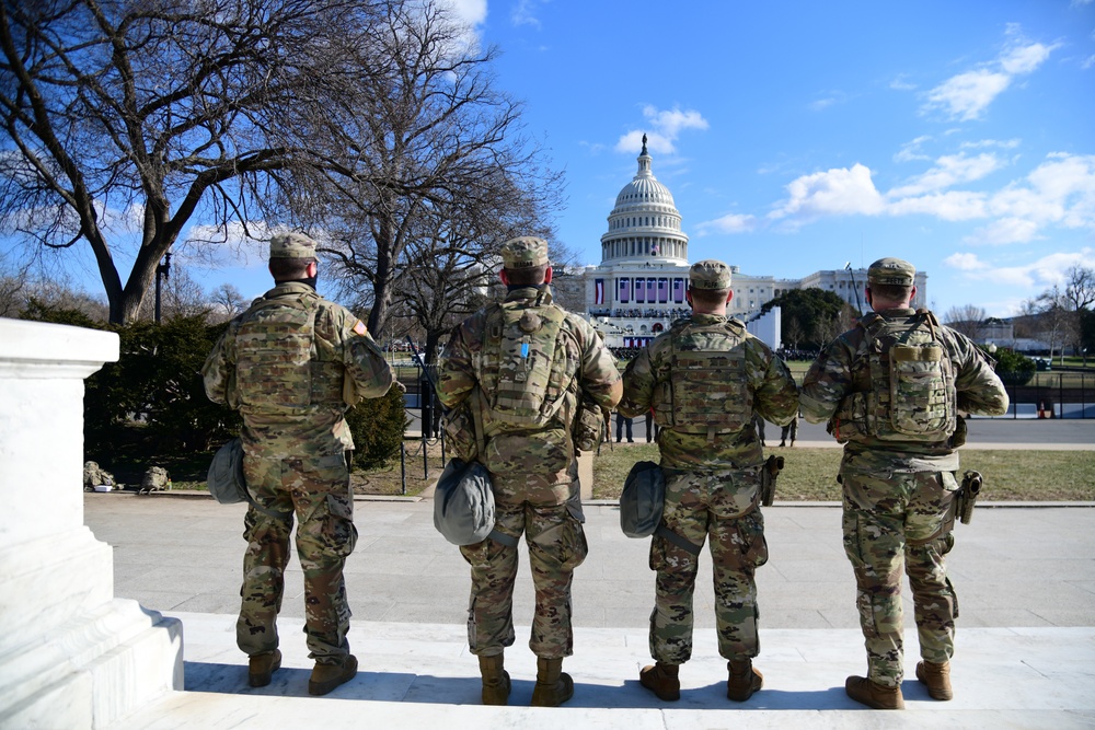 U.S. Soldiers with 3rd Battalion, 121st Infantry Regiment, Georgia National Guard, watch the inauguration in front of the Capitol in Washington, D.C., Jan. 20, 2021