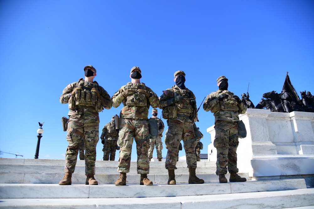 U.S. Soldiers with 3rd Battalion, 121st Infantry Regiment, Georgia National Guard, watch the inauguration in front of the Capitol in Washington, D.C., Jan. 20, 2021