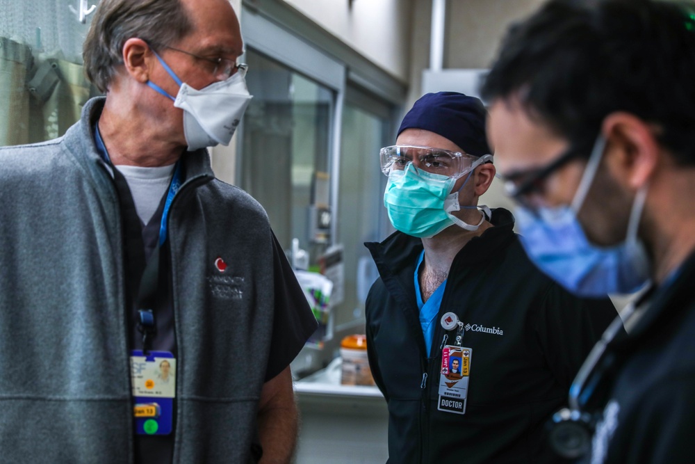 U.S. service members, local medical professional work together