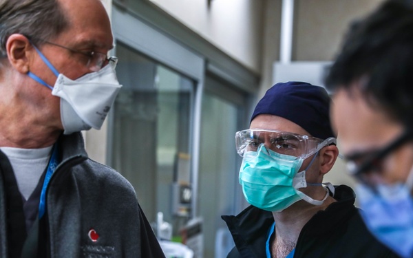 U.S. service members, local medical professional work together